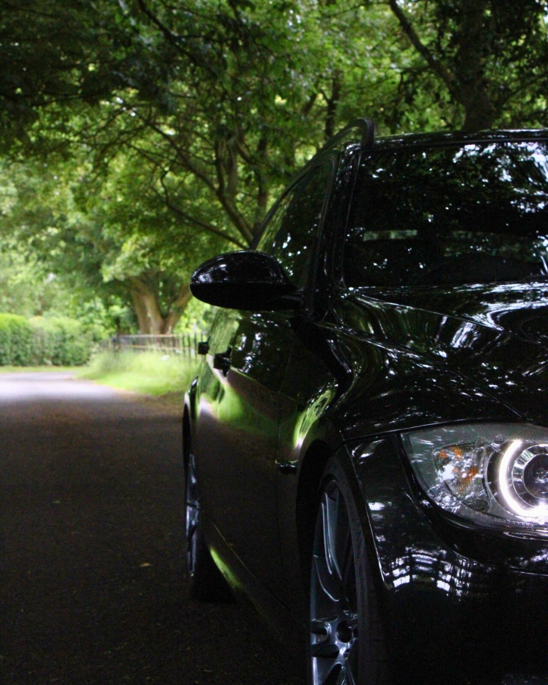 Flight and Flora's photography of the left side of a Black BMW from a front angle